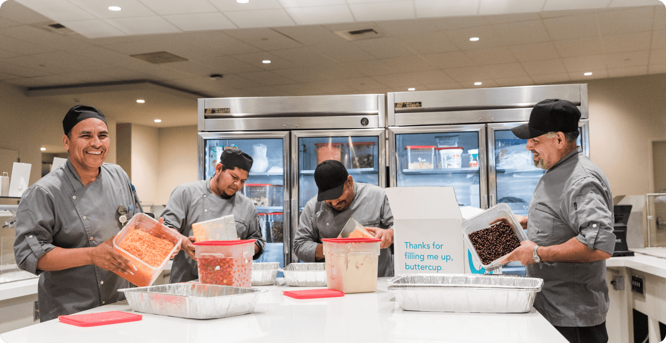 young-female-volunteers-giving-containers-with-free-food-people-need